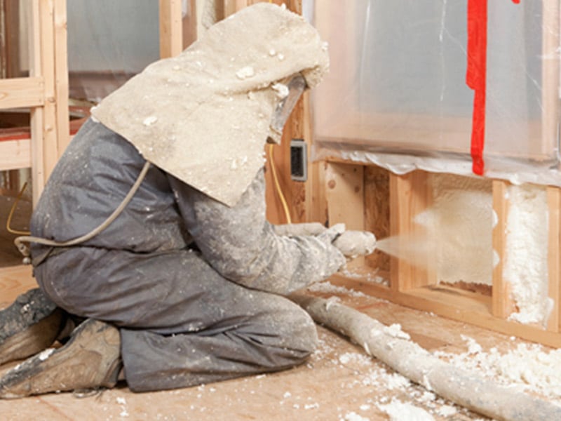 man blowing insulation